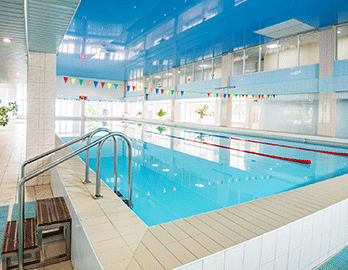 view-of-indoors-swimming-pool-with-metal-ladder-XSB5CJD.png